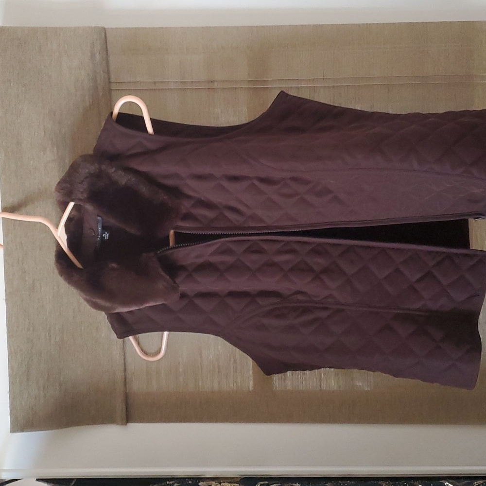 Brown vest with fur collar.